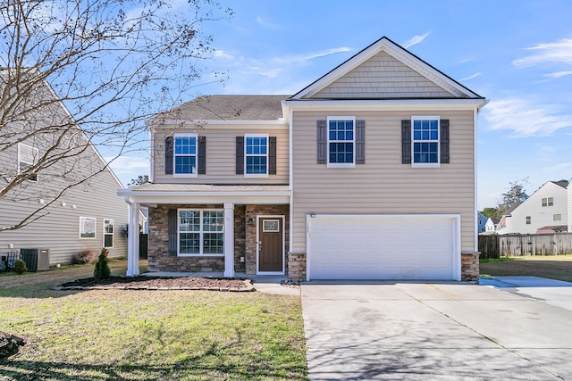 view of front facade featuring concrete driveway, a front yard, cooling unit, a garage, and stone siding