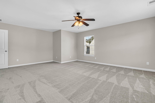 unfurnished room with visible vents, baseboards, carpet, and a ceiling fan