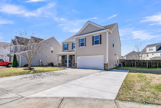 view of front facade featuring driveway, an attached garage, central AC, and a front lawn