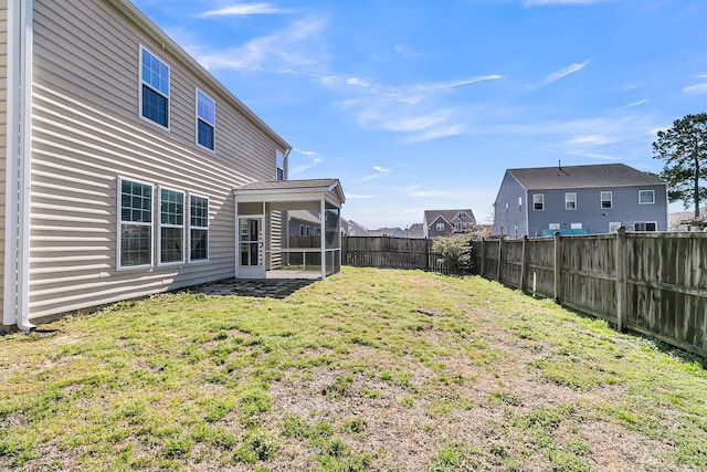 view of yard with a fenced backyard and a sunroom