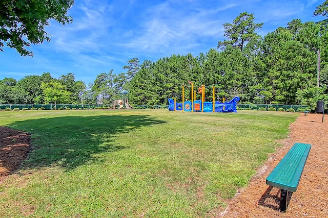 view of yard with playground community and fence