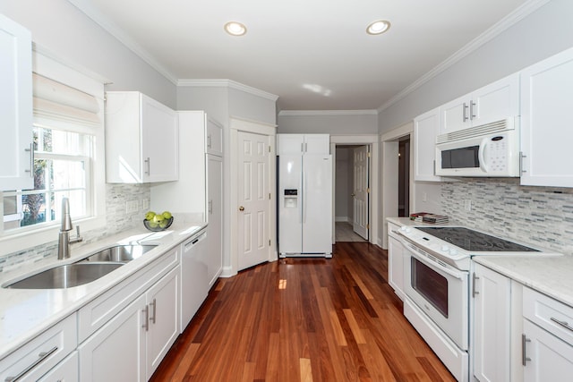 kitchen featuring ornamental molding, sink, white cabinets, and white appliances