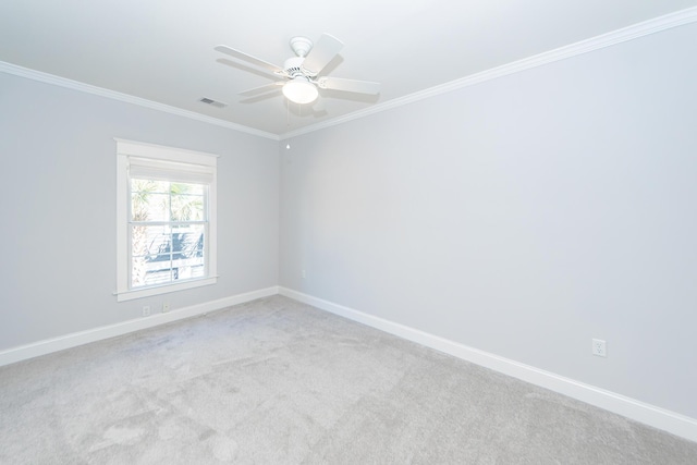 carpeted empty room featuring crown molding and ceiling fan