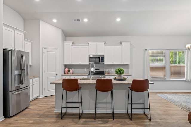 209 Country Gate Ln, Summerville, SC 29485 - kitchen featuring appliances with stainless steel finishes, white cabinetry, a kitchen island with sink, a sink, and recessed lighting