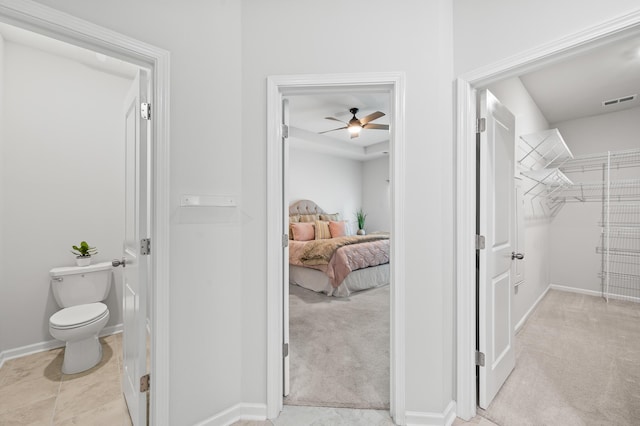 209 Country Gate Ln, Summerville, SC 29485 - ensuite bathroom with a ceiling fan, toilet, a walk in closet, and baseboards