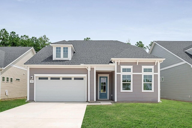 view of front of property with a front lawn and a garage