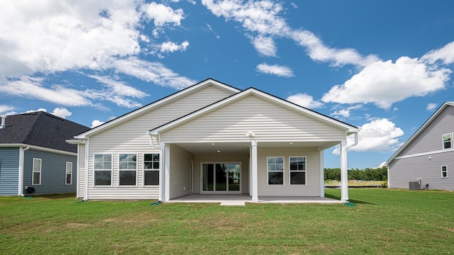 rear view of property with a patio area, central air condition unit, and a lawn