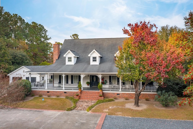 cape cod house with a front lawn and a porch