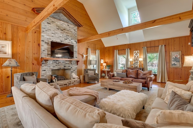 living room with a fireplace, light hardwood / wood-style floors, high vaulted ceiling, and plenty of natural light