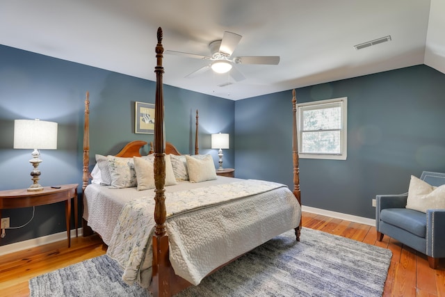 bedroom with ceiling fan, wood-type flooring, and vaulted ceiling