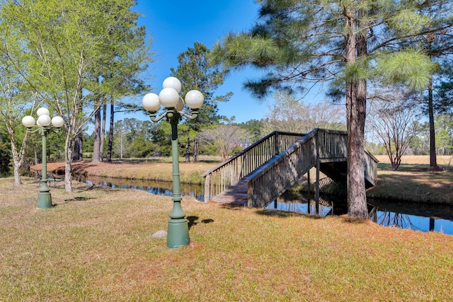 view of jungle gym with a yard and a water view