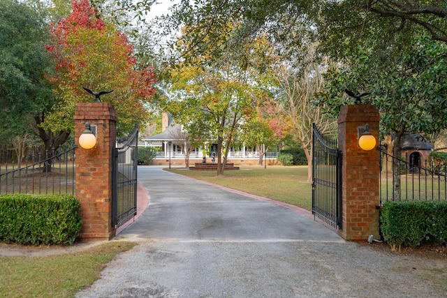 view of gate with a yard