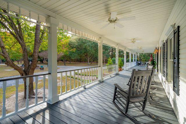 wooden terrace featuring ceiling fan and a porch