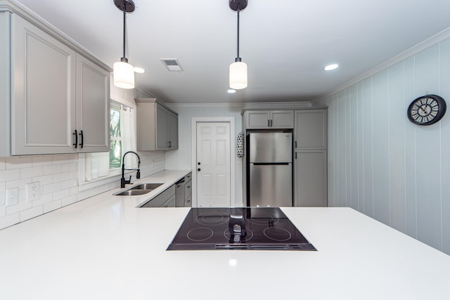 kitchen featuring pendant lighting, gray cabinetry, sink, and stainless steel appliances