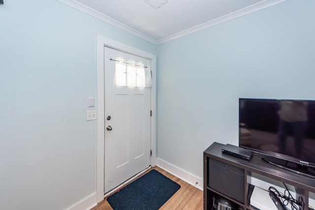 entrance foyer with crown molding and light hardwood / wood-style flooring