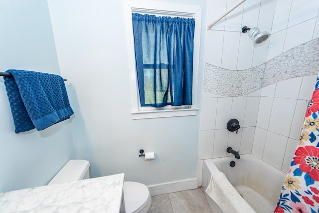 full bathroom featuring shower / bath combo with shower curtain, vanity, and toilet