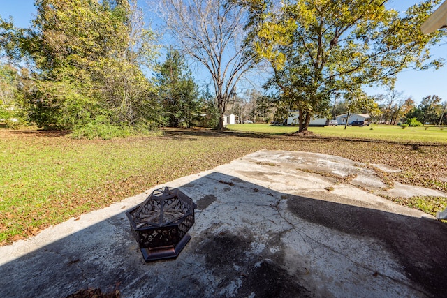 view of yard with a fire pit and a patio area