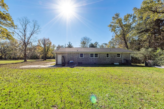 rear view of property featuring a lawn