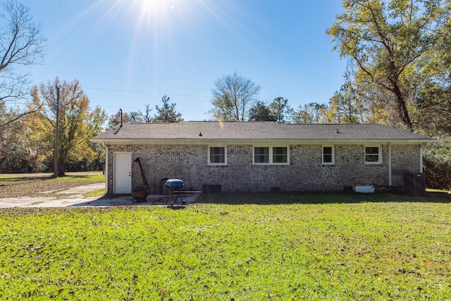 rear view of house featuring a yard and a patio area