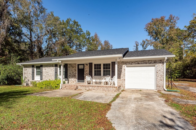 ranch-style house with a front lawn, covered porch, and a garage