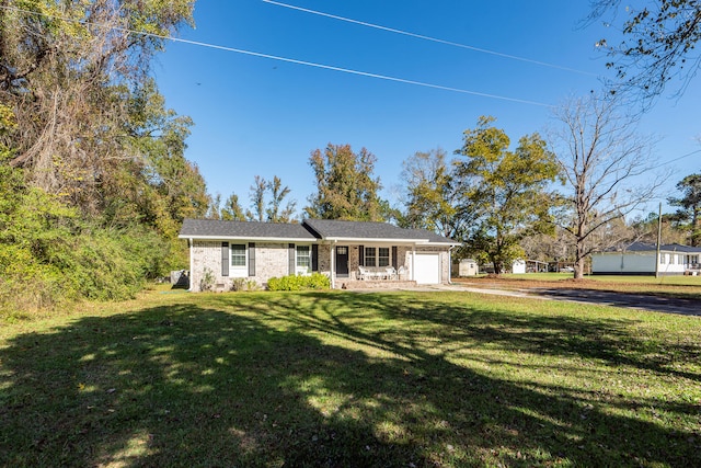 single story home with a front yard and a garage