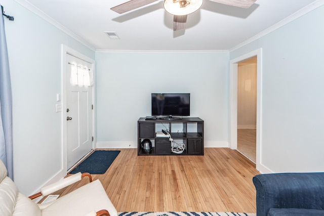 living room featuring ornamental molding, ceiling fan, and hardwood / wood-style flooring