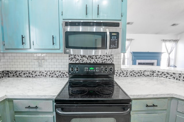 kitchen featuring decorative backsplash and black / electric stove