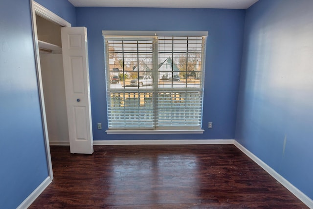 spare room with dark hardwood / wood-style flooring