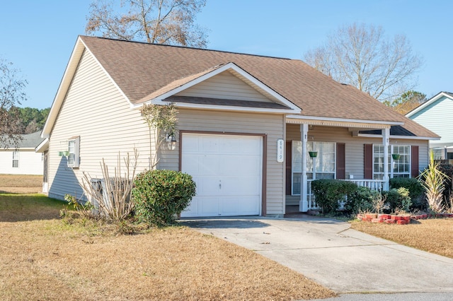 ranch-style home with covered porch, a front yard, and a garage