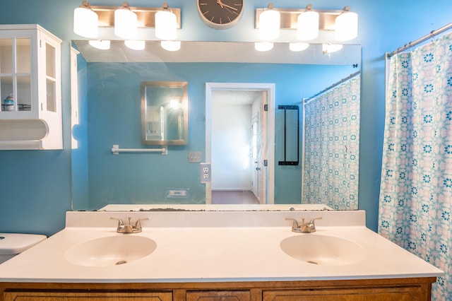 bathroom featuring a shower with curtain, vanity, and toilet