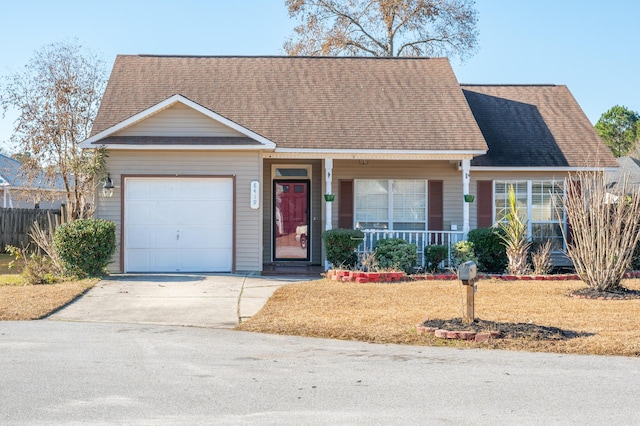 view of front of house featuring a front yard, a porch, and a garage