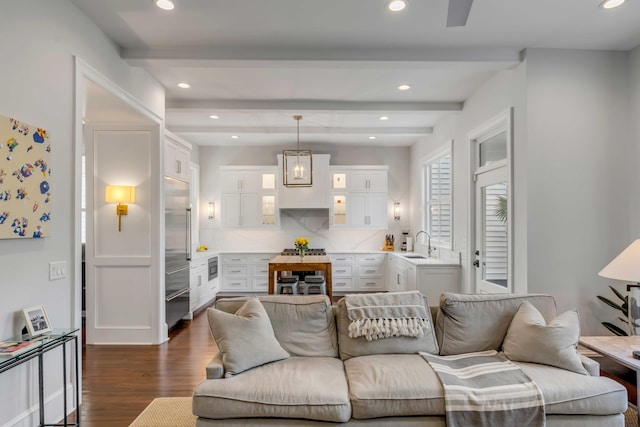 living area featuring recessed lighting, beamed ceiling, and dark wood finished floors