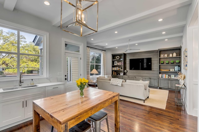 dining space with recessed lighting, a wealth of natural light, dark wood-type flooring, and beam ceiling