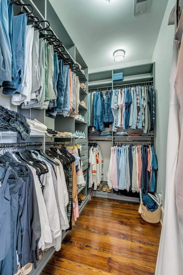 walk in closet with visible vents and wood finished floors
