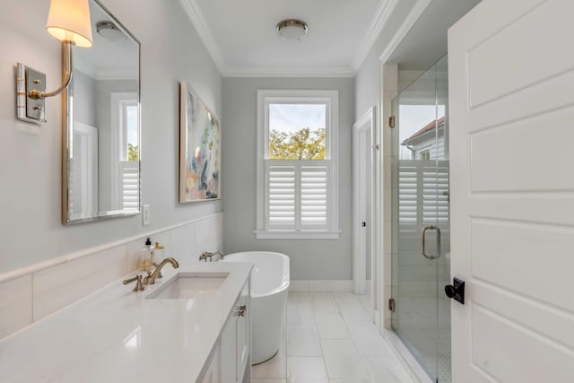 bathroom featuring a stall shower, a soaking tub, crown molding, and vanity