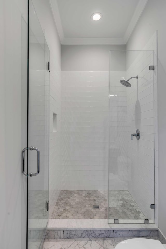 bathroom featuring ornamental molding, a shower stall, and recessed lighting