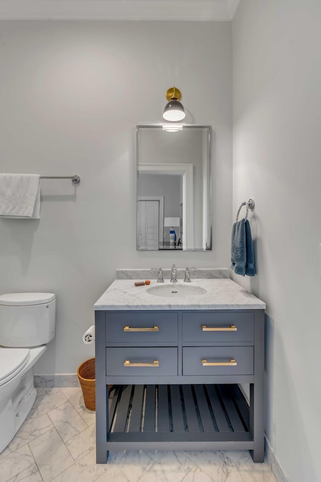 bathroom with baseboards, marble finish floor, vanity, and toilet
