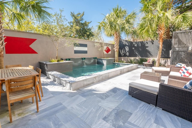 view of pool with a patio, outdoor dining area, a fenced in pool, and a fenced backyard