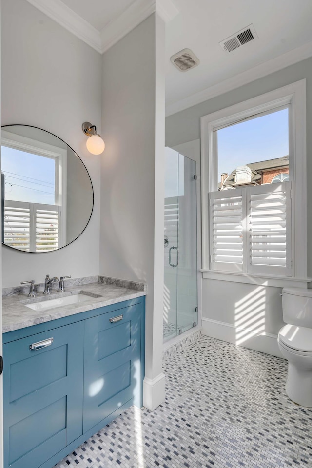 full bathroom featuring toilet, vanity, visible vents, a stall shower, and baseboards