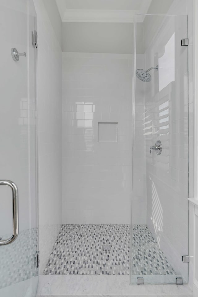 full bathroom featuring a shower stall and ornamental molding