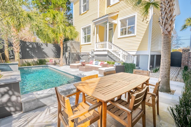 view of pool featuring an outdoor hangout area, a patio area, a fenced in pool, and a fenced backyard