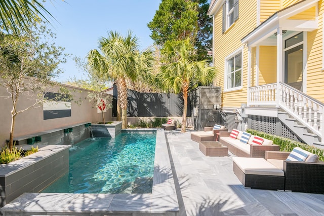 view of swimming pool featuring a patio area, an outdoor living space, a fenced backyard, stairway, and a fenced in pool