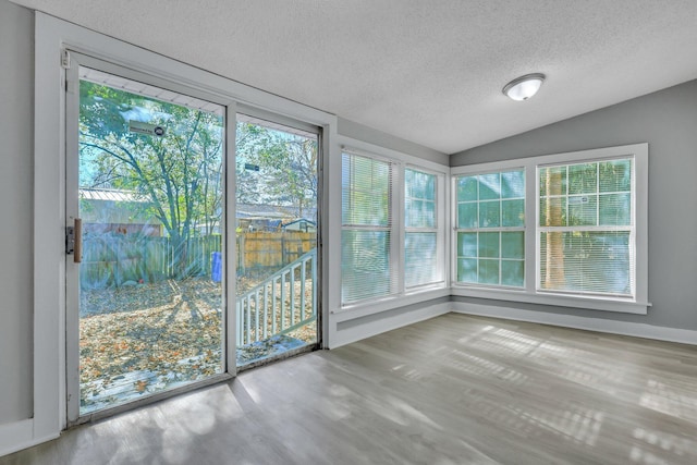 unfurnished sunroom featuring lofted ceiling