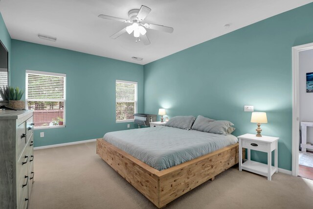 carpeted bedroom featuring baseboards and a ceiling fan
