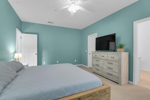 bedroom with light carpet, baseboards, and a ceiling fan