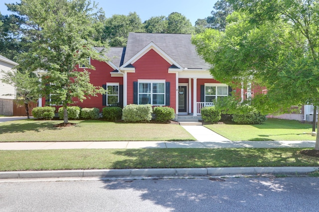 view of front of property featuring a front yard and roof with shingles