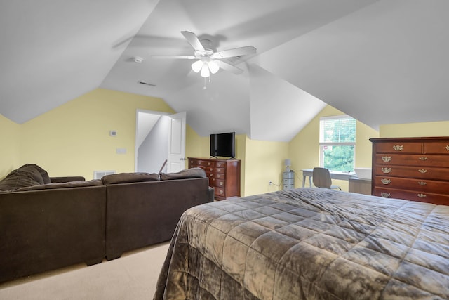 carpeted bedroom with vaulted ceiling and a ceiling fan