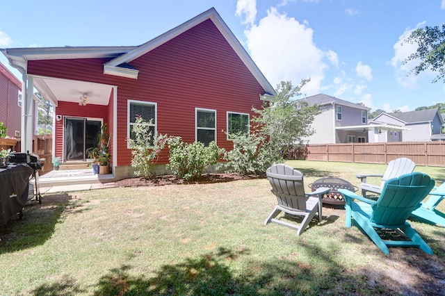 rear view of house featuring an outdoor fire pit and a ceiling fan