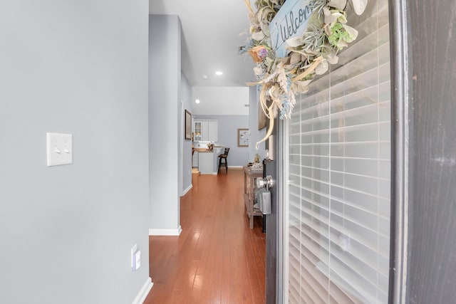 hallway with wood-type flooring, recessed lighting, and baseboards