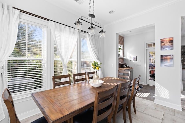 dining space with crown molding and a healthy amount of sunlight